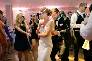 The bride and groom dance during their reception with the bride wearing a reception dress.