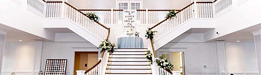 The staircase in the Kendall Point Grand Ballroom, a top Texas wedding venue, decorated with flowers from the ceremony.