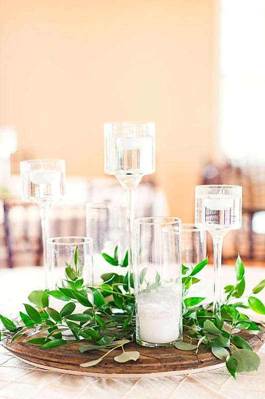 Candles in glass cannisters are perfect centerpieces for a budget wedding.