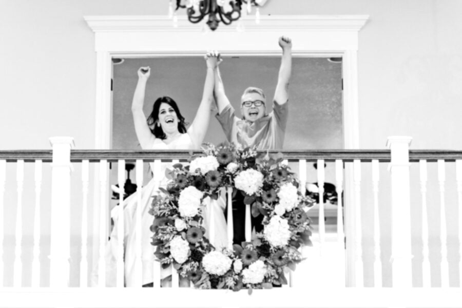 A bride and groom celebrate on the Kendall Point balcony.