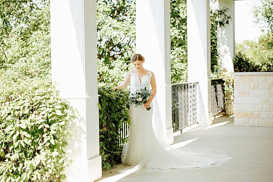 Bride poses on Kendall point porch.