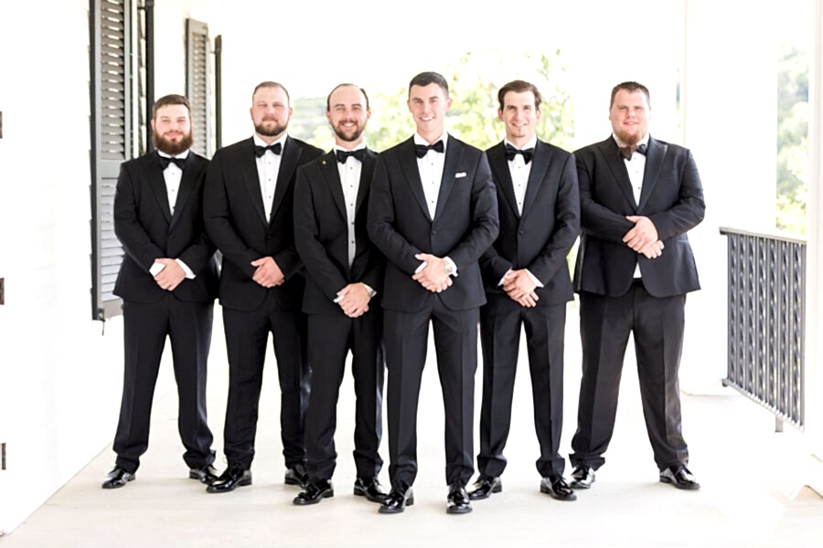 The groom Brian and his groomsmen are all smiles on the private porch off the groom’s suite.