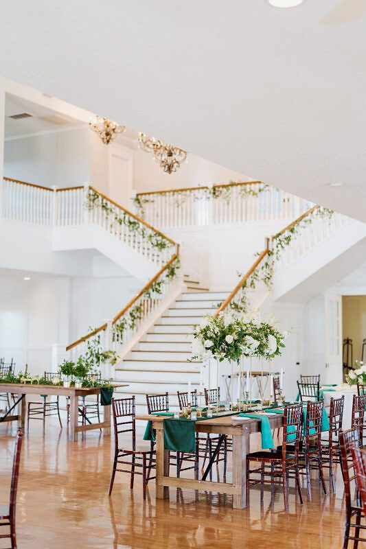 Farmhouse tables with velvet emerald green table runners and accents.