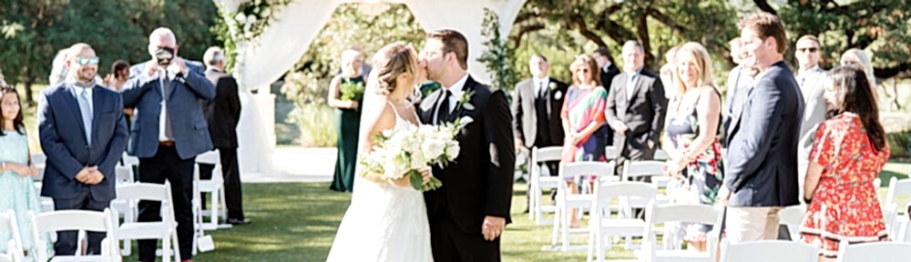 Bride and groom kiss following wedding ceremony