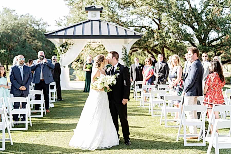 Bride and groom kiss following wedding ceremony