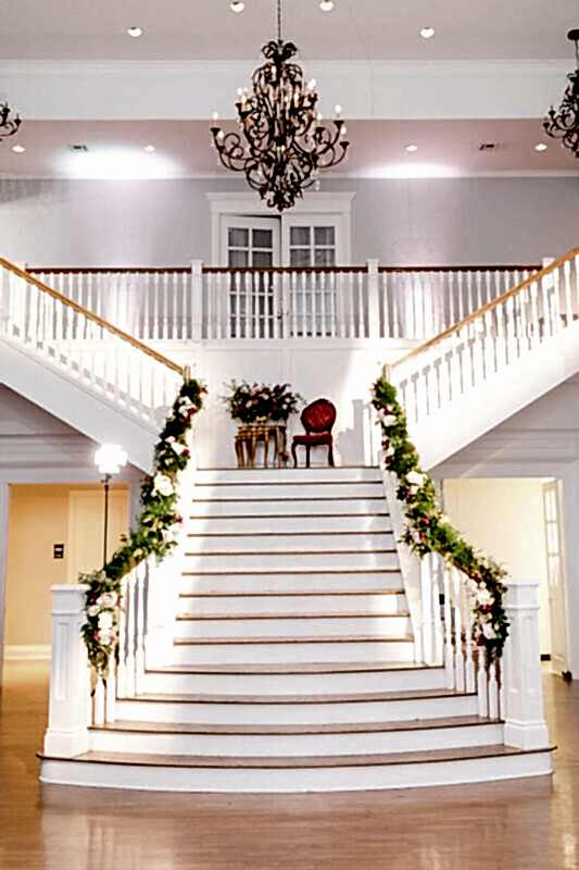 Soft pink lighting makes for a romantic staircase in the Kendall Point Grand Ballroom.