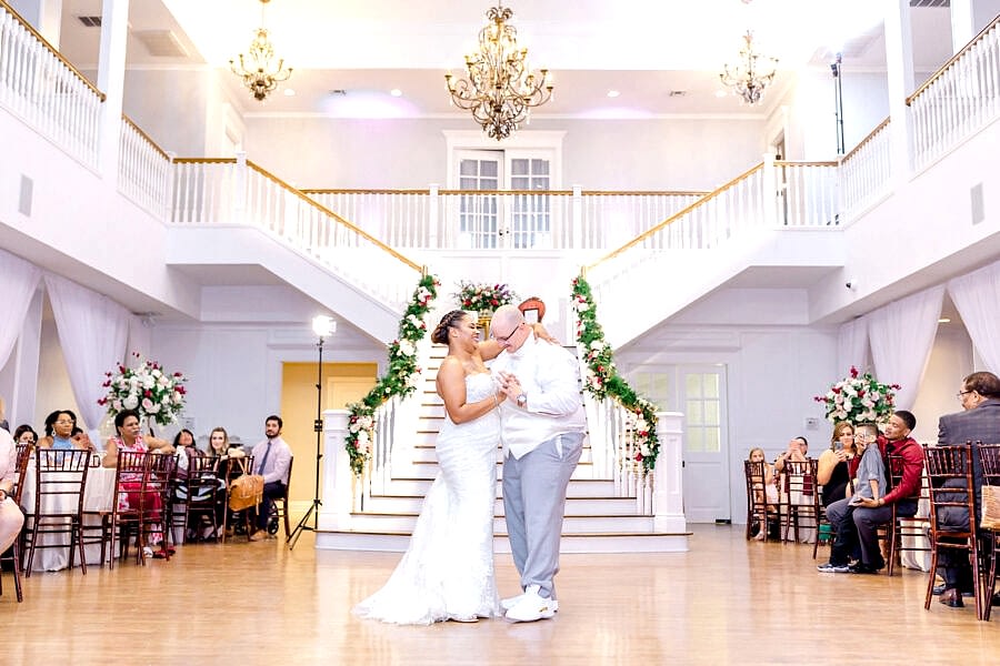 Bride and groom enjoying their first dance while friends and family watch from their seats during wedding reception at Kendall Point.