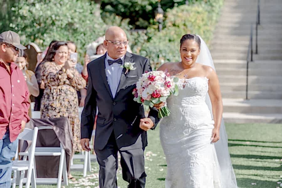 The bride's father walks her down the aisle.