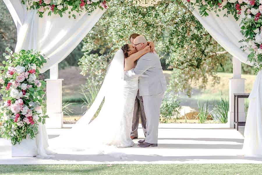 Bride and groom kiss during summer wedding at Kendall Point