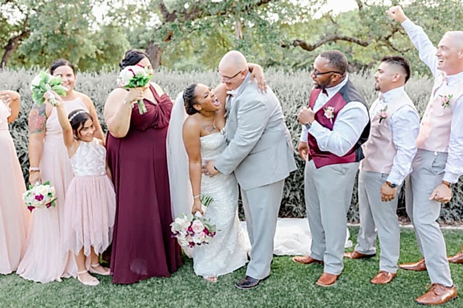 Wedding party cheers and celebrates.