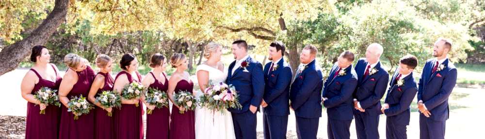 A bride and groom flanked by their bridal parties.