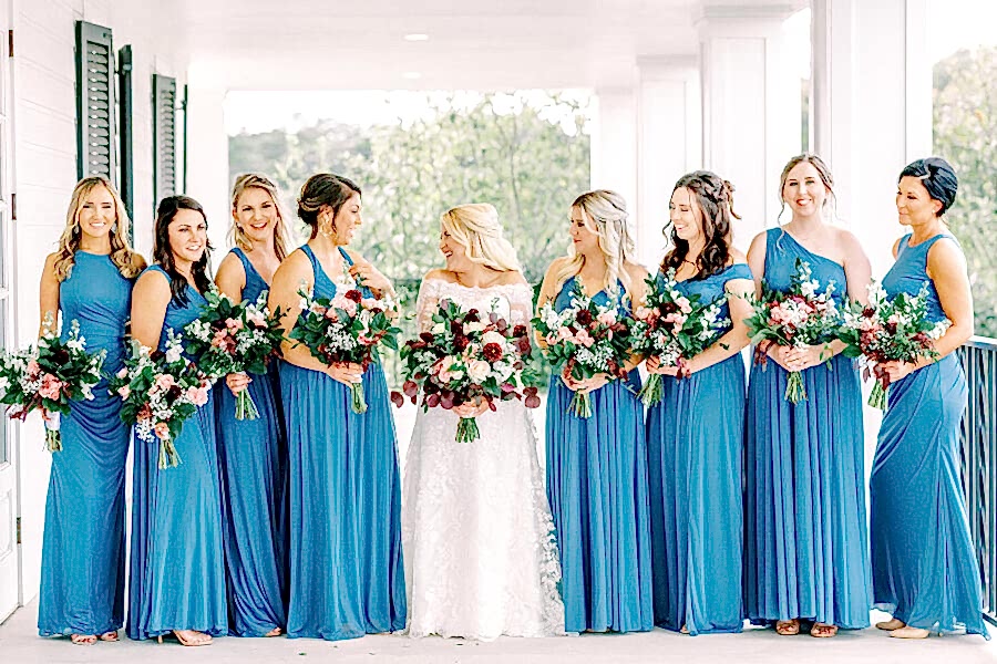 Bride posing with her bridesmaids on Kendall Point veranda