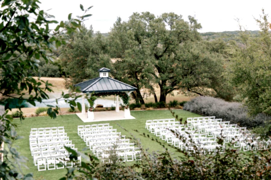 White chairs set up for an outdoor ceremony at Kendall Point.