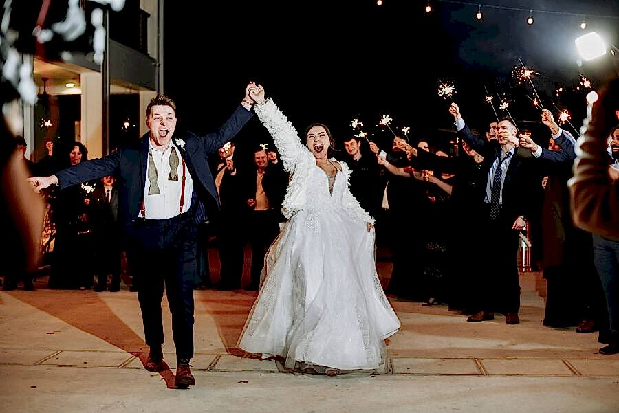 The bride and groom exit their reception at Kendall Point under sparklers.