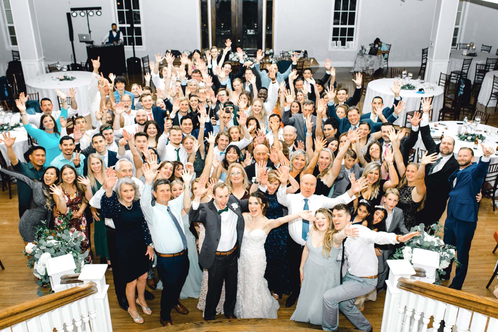 Wedding guests pose for a group photo at the base of the Kendall Point staircase.