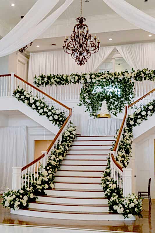Flowers adorn the grand staircase in the Kendall Point ballroom for a fall wedding.