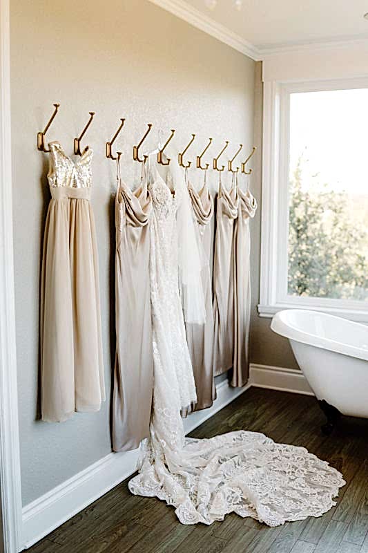 Wedding dress and bridesmaids dresses handing in Kendall Point bridal suite.