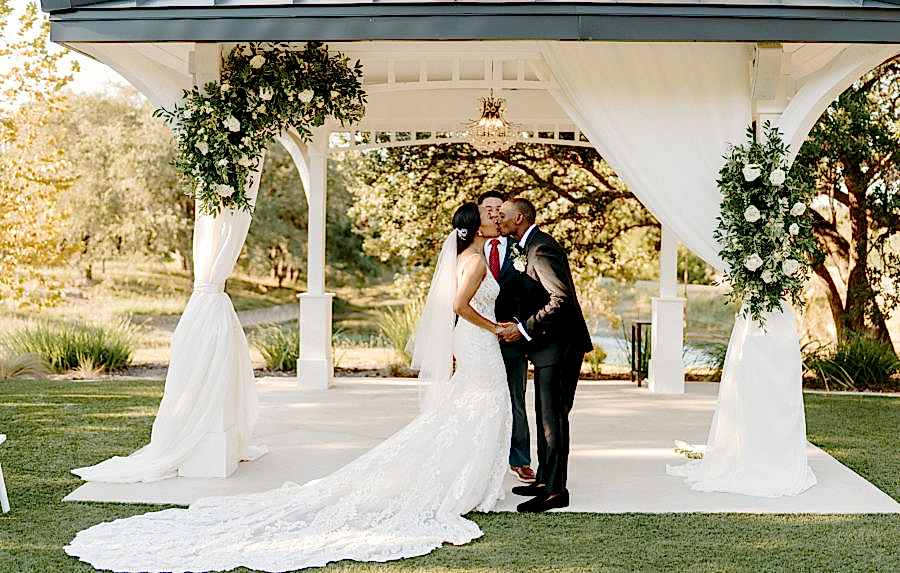Bride and groom kiss under the Kendall Point gazebo.