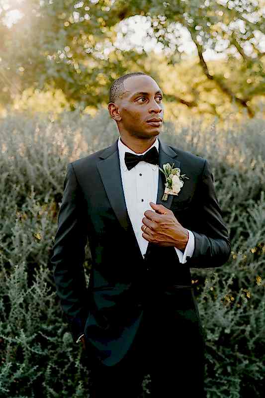 A groom poses before his wedding at Kendall Point.