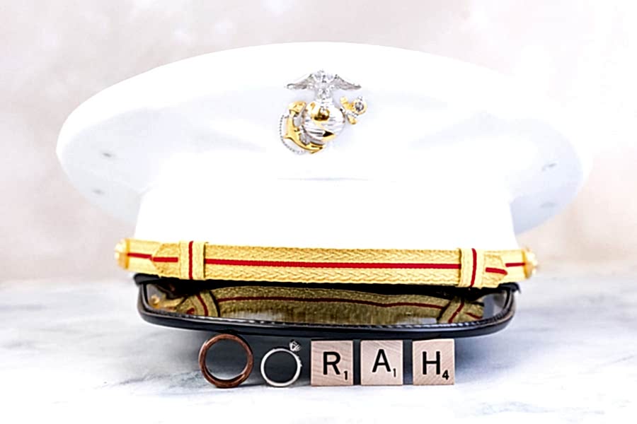 The groom's marine's cap over the ring's and scrabble tiles spelling "oorah."