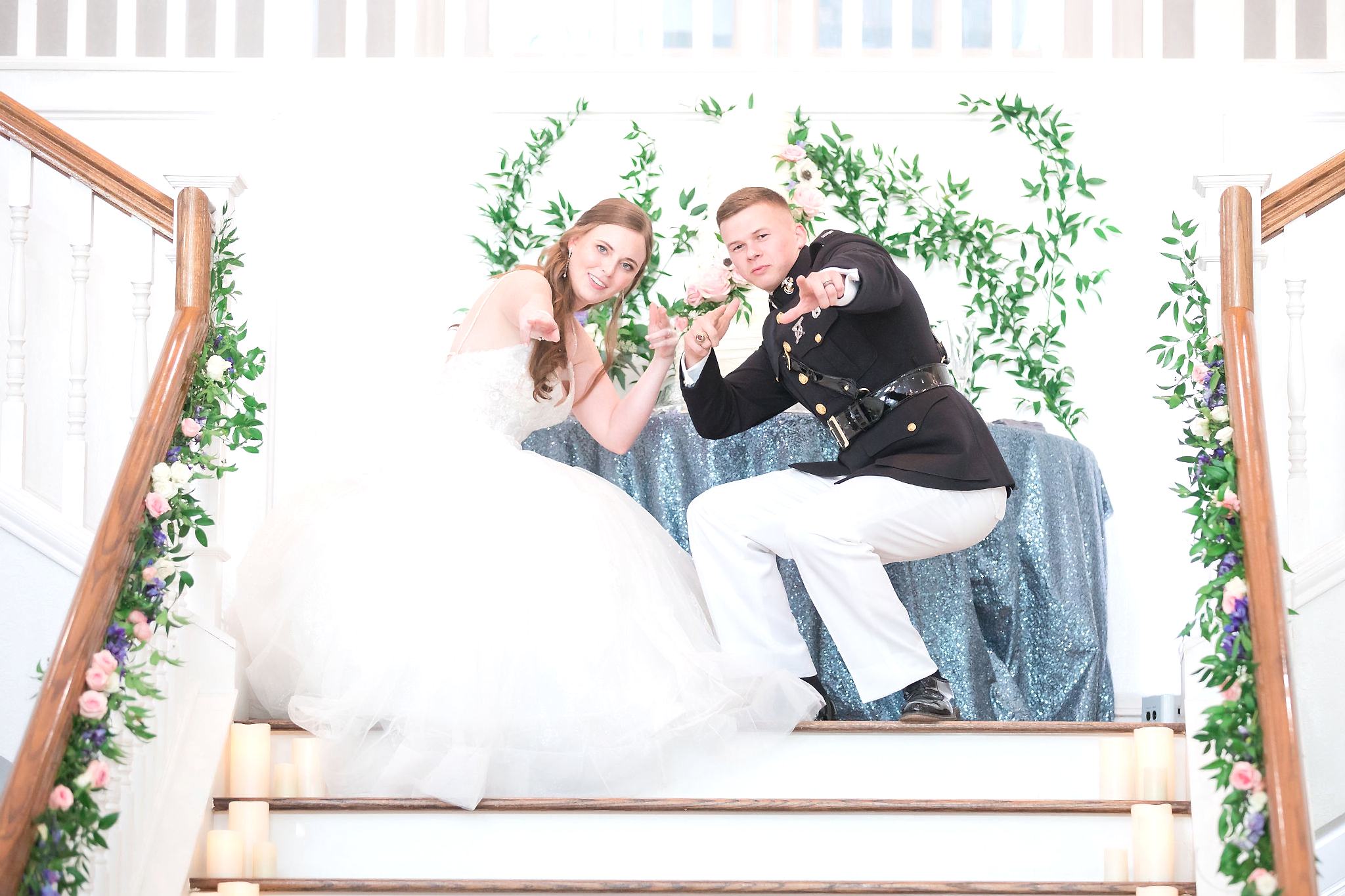 Bride and groom pose on the Kendall Point grand staircase