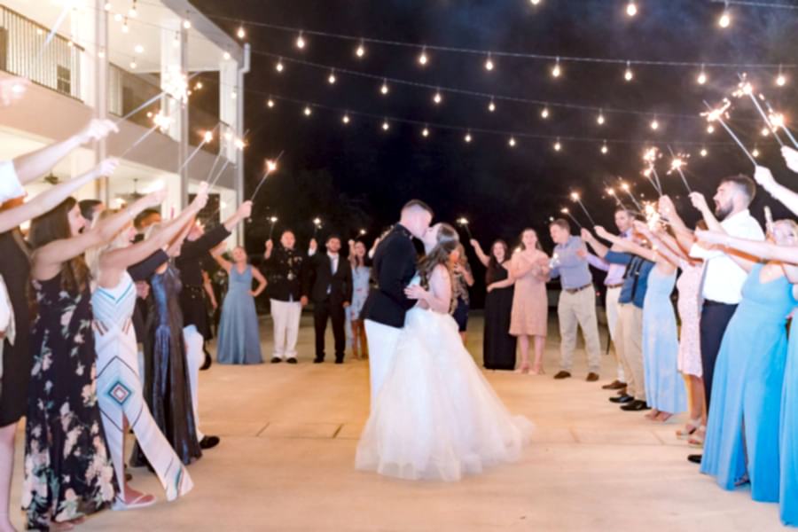 Bride and groom kiss during a dance.