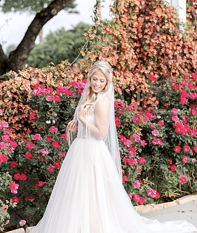 bride posing in front of summer flowers at kendall point