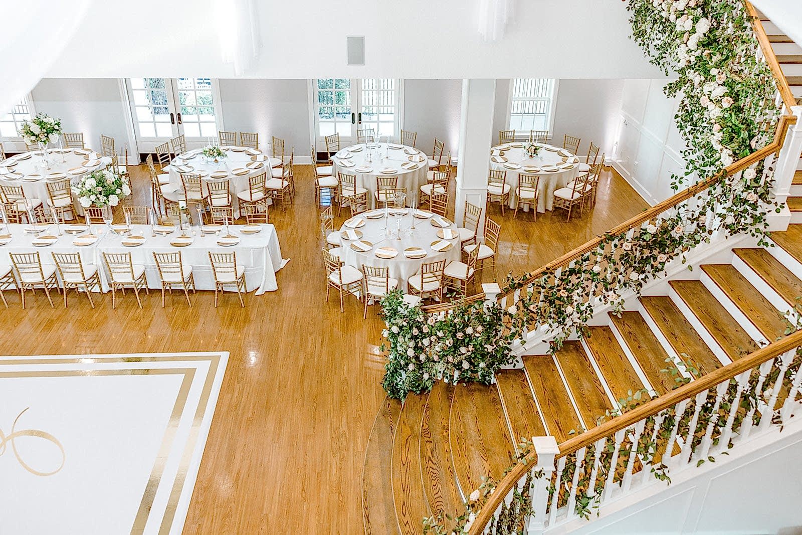 Kendall Point’s staircase decked with florals for wedding reception