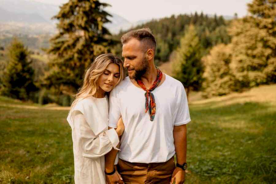 Engaged couple wearing coordinating clothes for their engagement photo outfits
