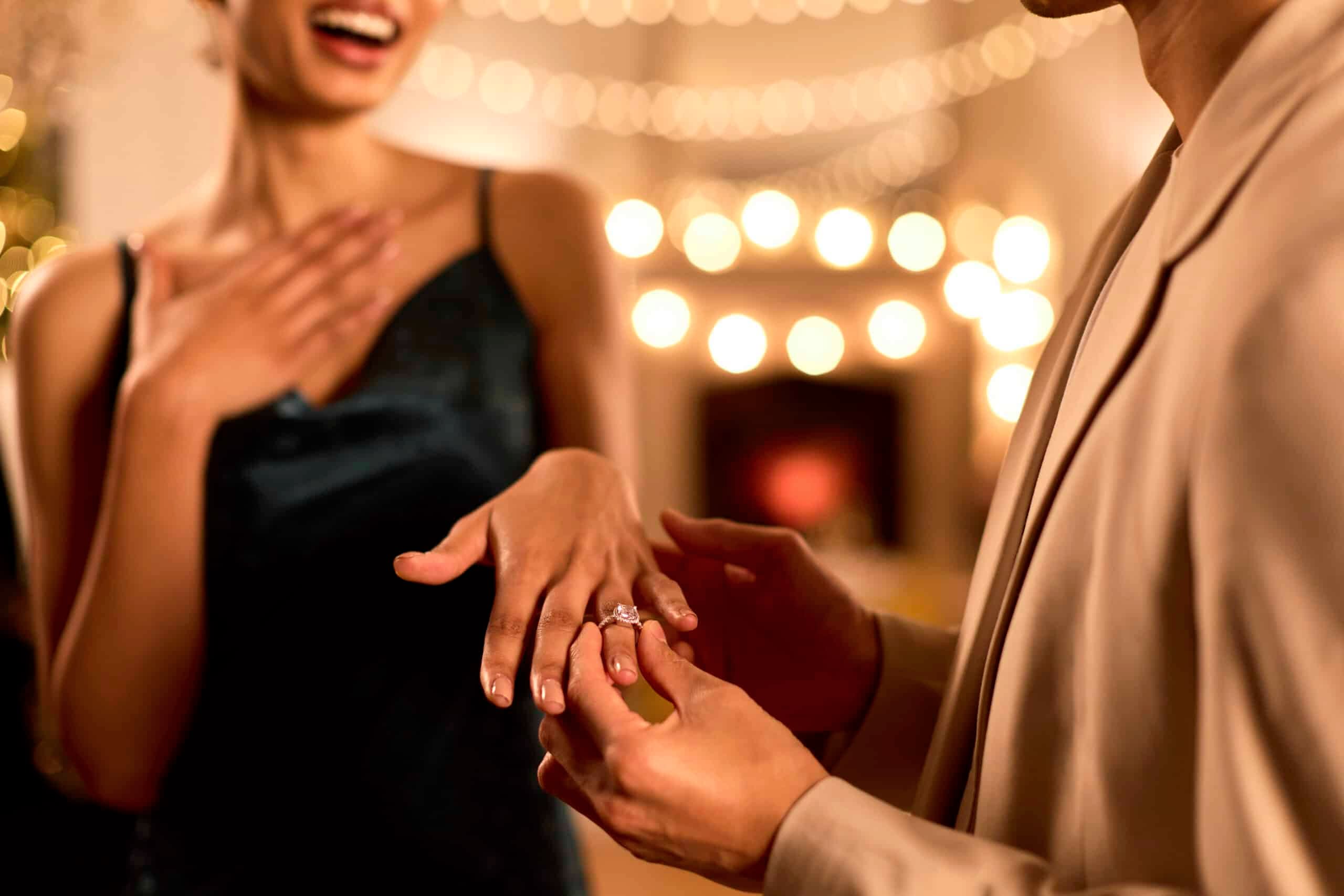 Woman showing off her engagement ring at an engagement party.