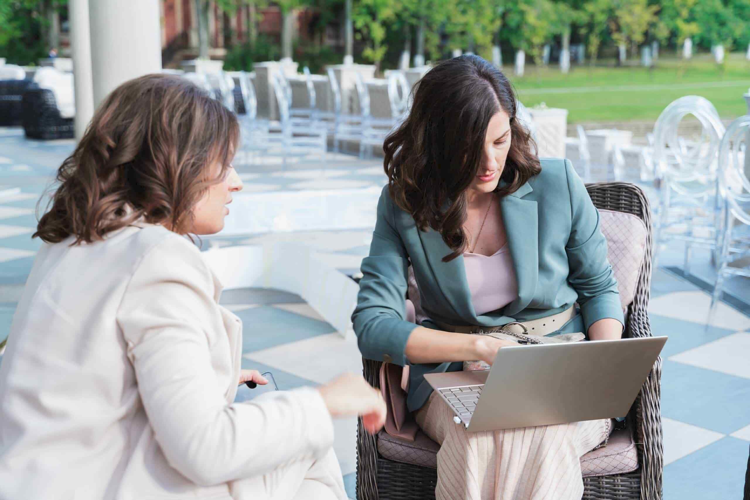Wedding planner taking with a bride about their upcoming wedding