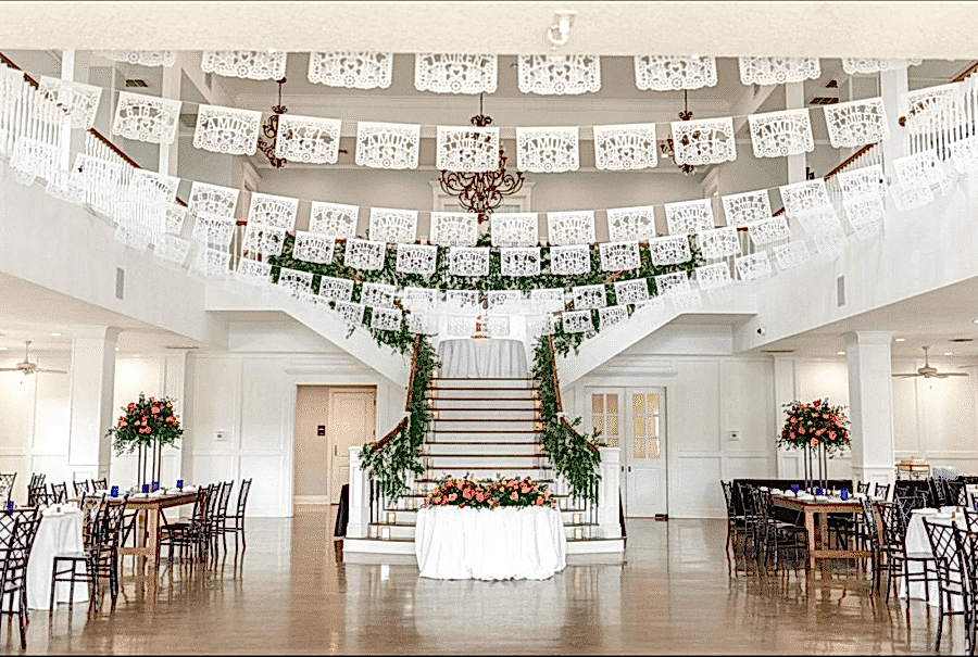 White papel picado decorations hang in the Kendall Point ballroom