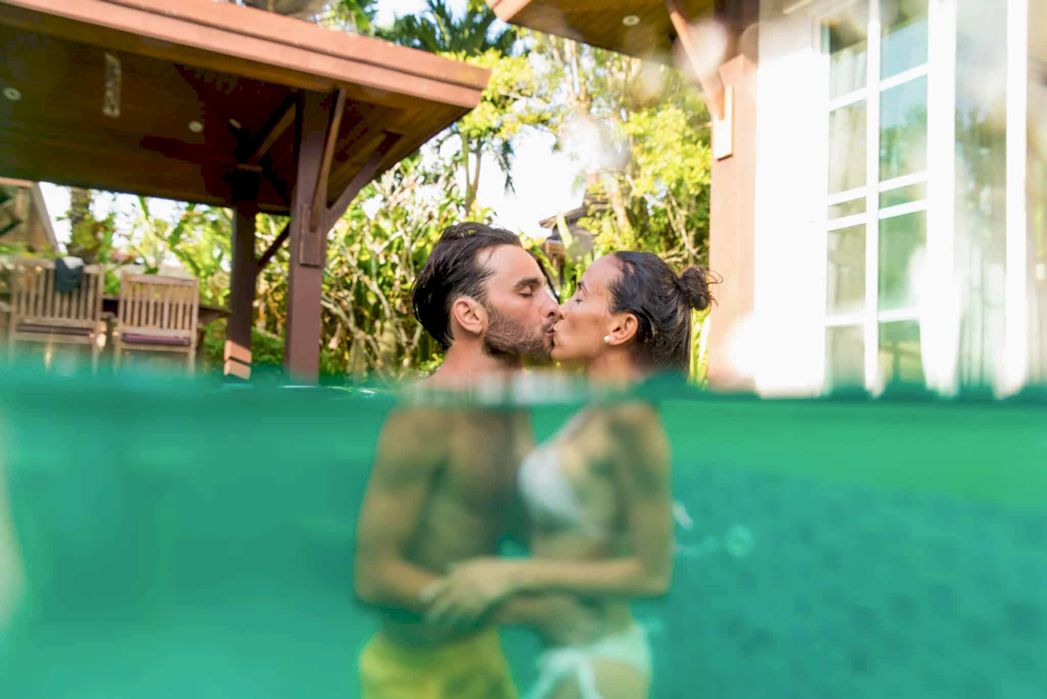 Couple of lovers in a beautiful villa with swimming pool in a tropical climate location