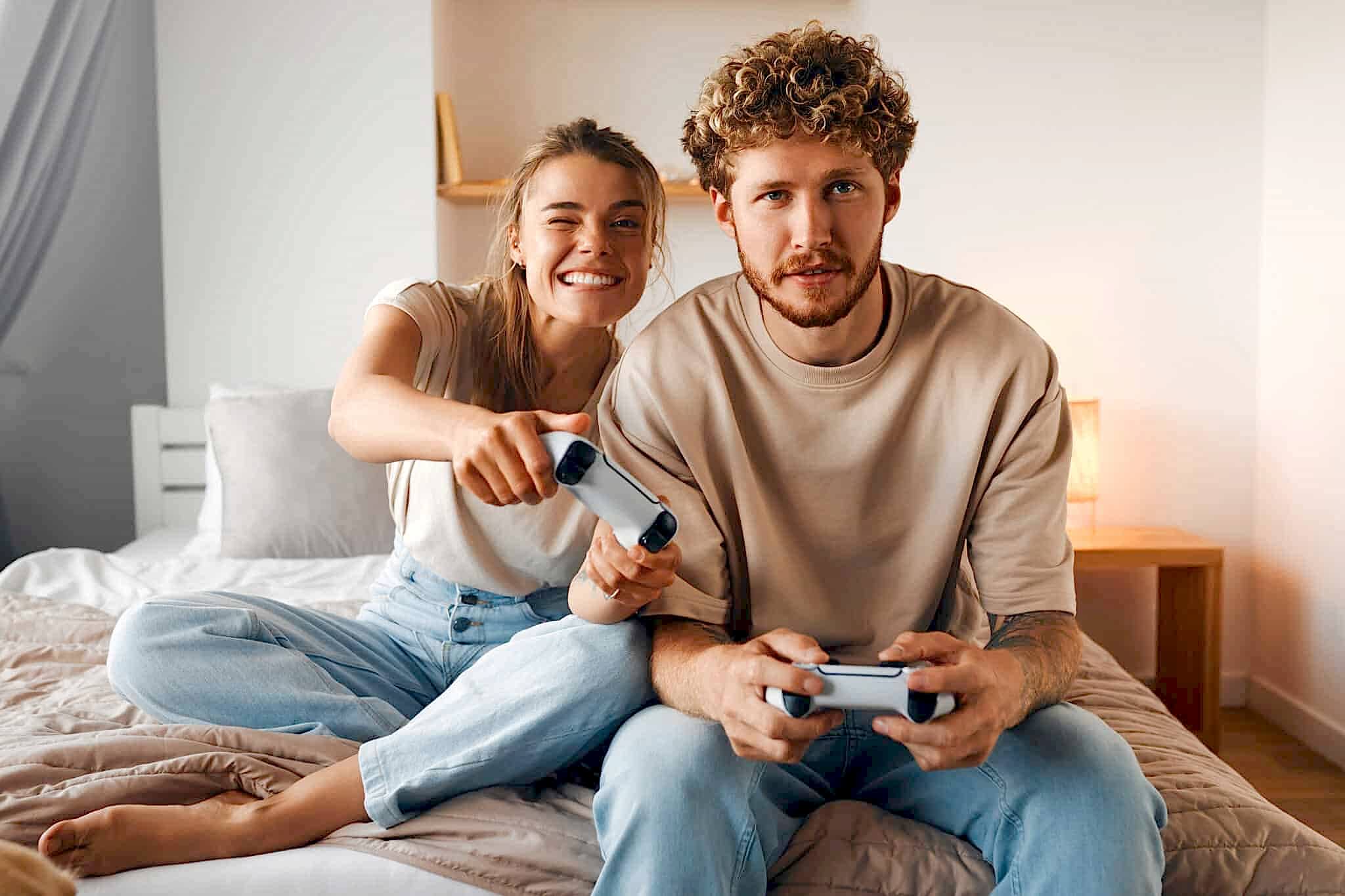 Young couple in love playing video games 