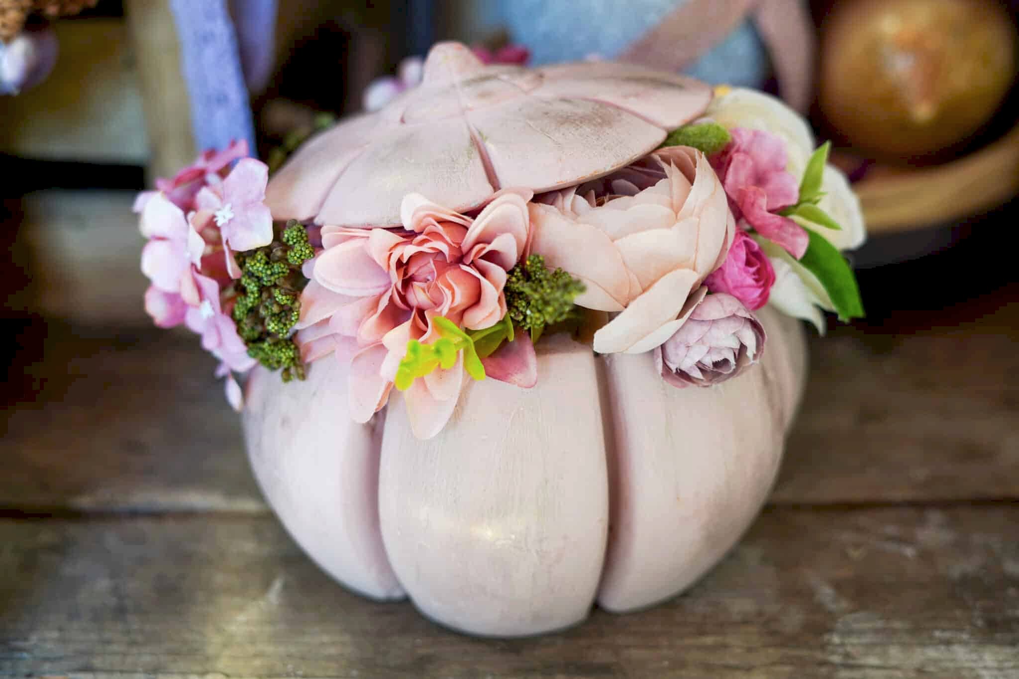 Floral arrangement inside of decorative pumpkin