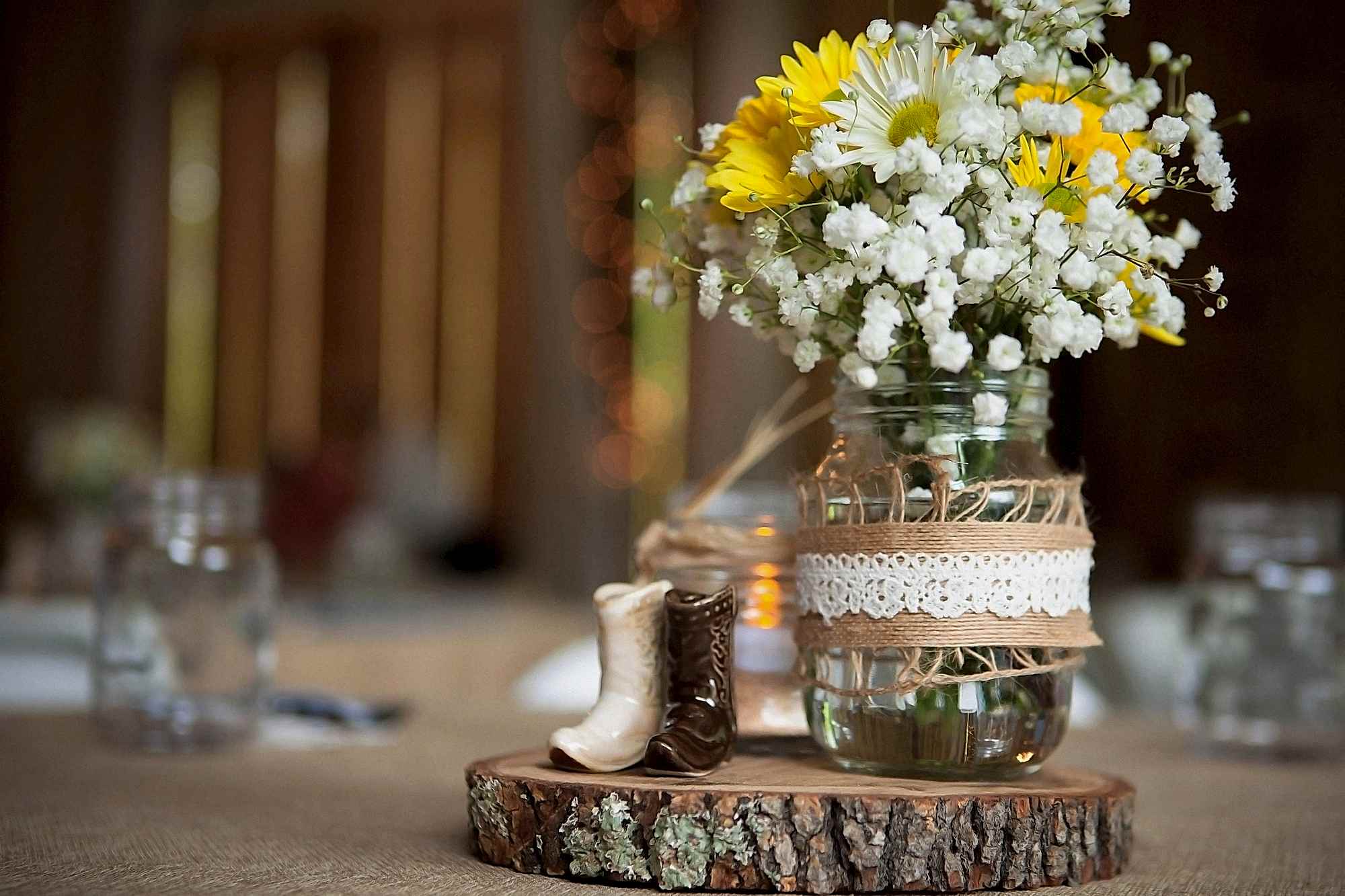 Rustic wedding centerpiece with wood and burlap