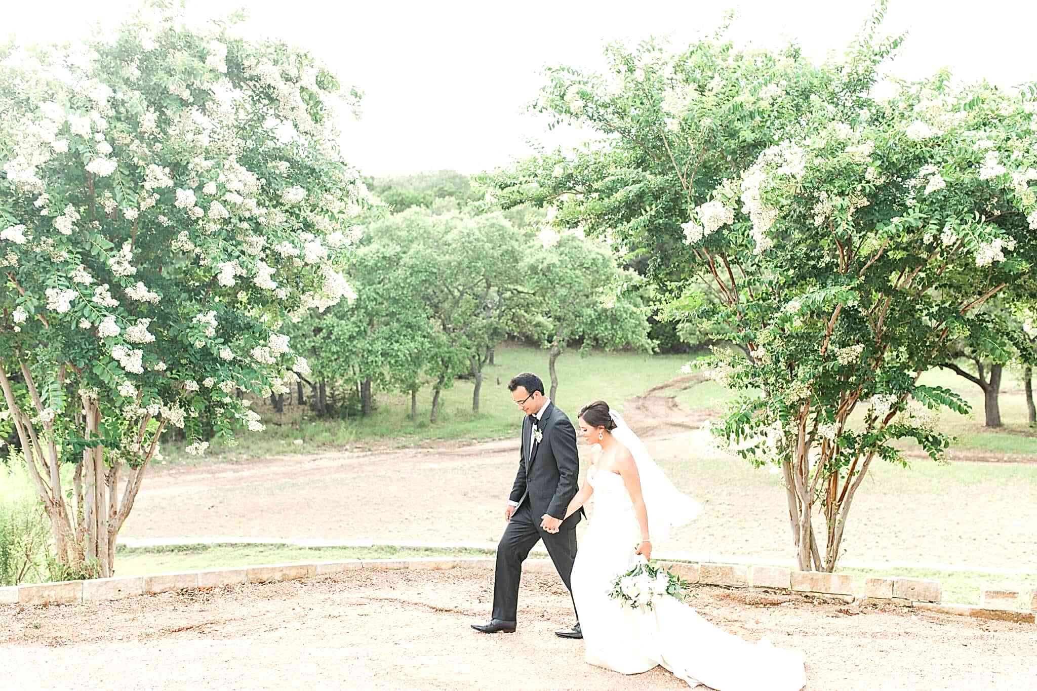 Bride and groom walking the grounds at Kendall Point for their destination wedding